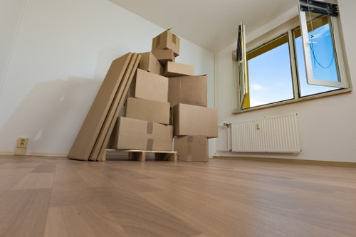 Professional movers loading household items for a Highbury move